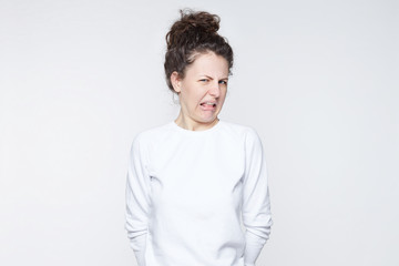 Ew. It's so gross. Young woman with disgusted expression repulsing something. Disgust concept....