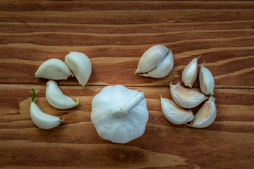 Close-up view of raw healthy organic garlic cloves on rustic wooden table, selective Focus