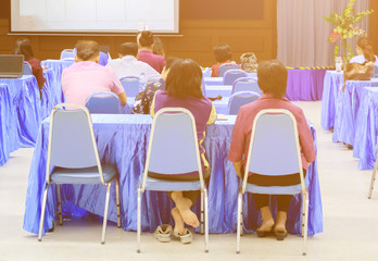 people backside in seminar business training conference meeting and screen project interior room with copy space add text. select focus with shallow depth