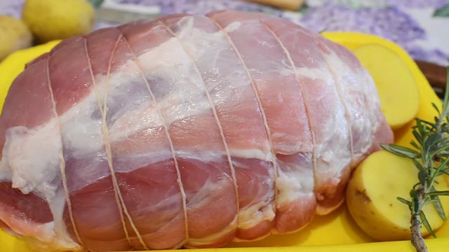 raw olled pork stuffed with bacon and tied with string