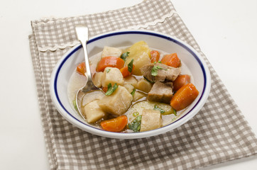 homemade irish stew in a deep dish with a blue border