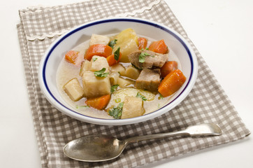 homemade irish stew in a deep dish with a blue border