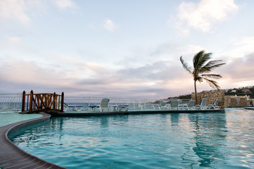 Pool with sea view in philipsburg, sint maarten. Swimming pool with blue water under evening sky. Beach vacation at Caribbean. Wanderlust, travel and trip