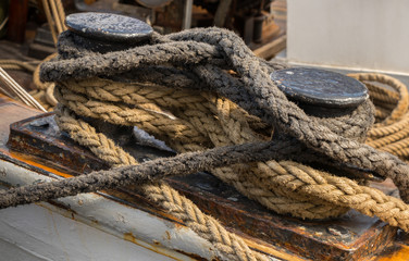 Close-up nautical knot rope tied around stake on ship