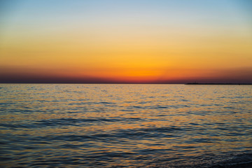 Fototapeta na wymiar Sunset over the Mediterranean sea in summer in Sicily, Italy