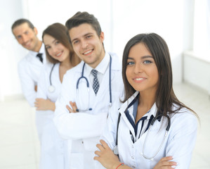 Fototapeta premium female doctor with group of happy successful colleagues