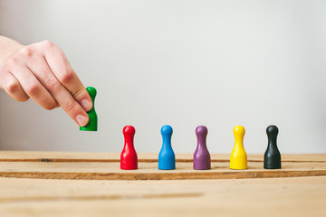 Business Team Building, diversity. Colorful pawns in a row representing a Diverse Workforce