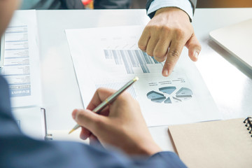 entrepreneurship new business start up meeting. Close up hand of young asian businessman taking note to notebook in the conference meeting for giving advice to new entrepreneurs
