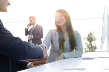 business woman shaking hands with a business partner.