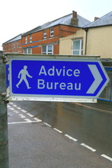 Advice Bureau sign on the street in Axminster, Devon