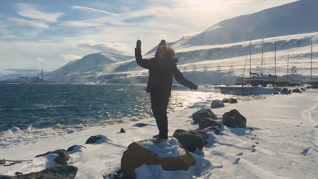young female in frozen landscape in Longyearbyen, Svalbard, Norway.