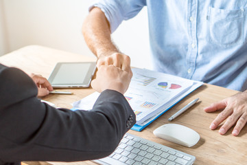 Team partner celebrating success collaboration. Two young business start up doing fists bump celebration business project plan successfull ready to start.