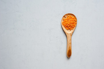 Handmade spoons. A large wooden spoon with lentils.