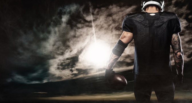 American football sportsman player over sky background. Sports banner and wallpaper with copyspace.