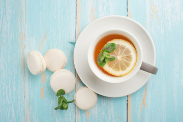 Tea with mint and lemon and white macaroons with mint