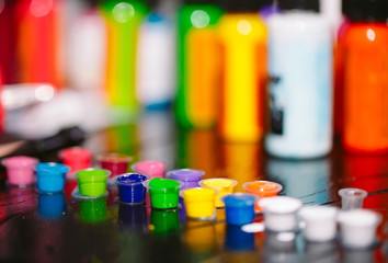 Tattoo ink poured into small caps