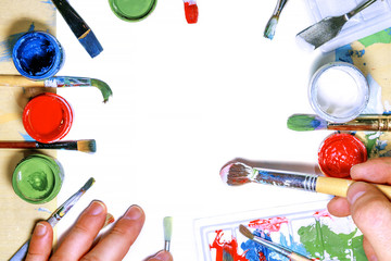 Color gouache jars on white background. Top view, copy space