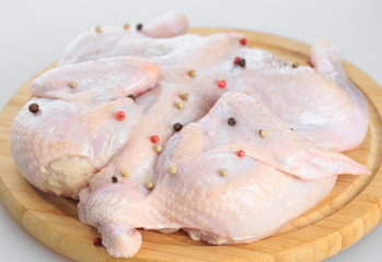 raw chicken carcass on the cutting board isolated on white background