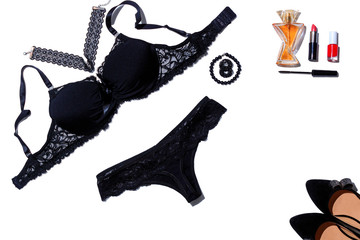 a set of black women's underwear - a bra, thong panties, black shoes, nail polish, lipstick and earrings. Concept erotic lingerie, date, flat lay