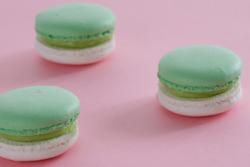 Three macaroons on a colored background