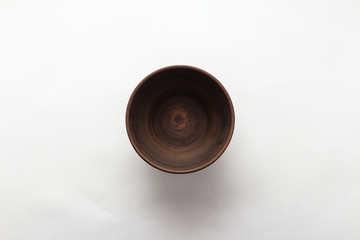 Empty brown plate on white background, top view, flat lay