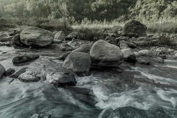 River water flowing through rocks at dawn