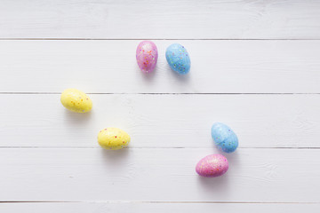 Naklejka na ściany i meble Happy easter eggs on color for holiday on wooden background top view flat lay