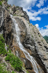 Fototapeta na wymiar Waterfall on the rock. Named - Shirlak - Girl's tears . Altai, Siberia, Russia.
