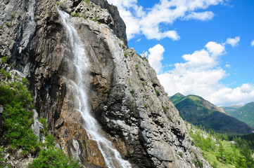 Fototapeta na wymiar Waterfall on the rock. Named - Shirlak - Girl's tears . Altai, Siberia, Russia.