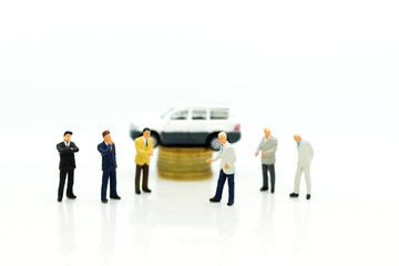 Miniature people : Businessman standing with car. Image use for Advertising product in the market today, competition on the business trading.