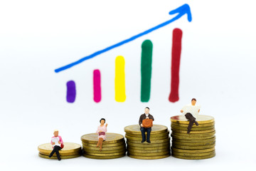 Miniature people: Businessman sitting on stack of coins, display graphs, profit margins of ...