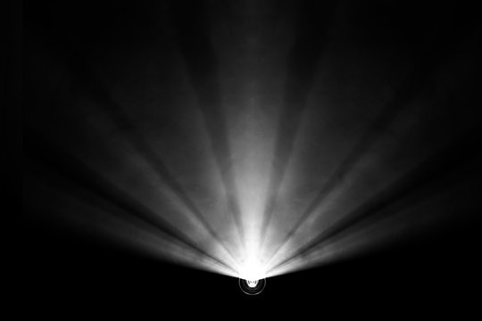 black and white color . projector beautiful spotlight . wide lens equipment for show presentation at night . smoke abstract background . digital monitor for multimedia teach .