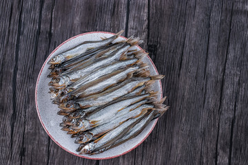 Fototapeta premium Capelin smoked on brown wooden table.
