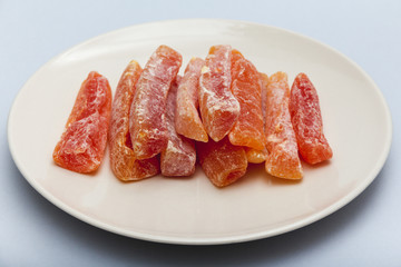sweet papaya and dried pieces in a white plate
