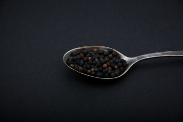 Black pepper on the metal spoon