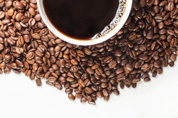 Coffee cup on spilled coffee beans,