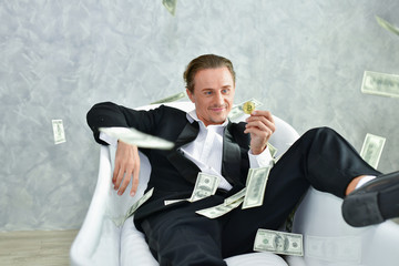 Concept Very wealthy businessman. Businessman is happy with his money.A businessman showing his...