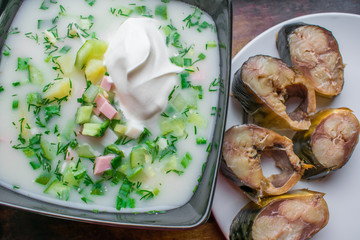 Cold, vegetable and appetizing okroshka, with smoked mackerel fish, cold home-made soup with sour...