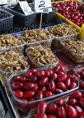 Fruits and nuts in plastic bowls