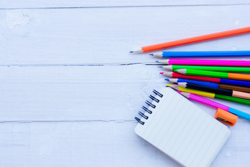 School items on a wooden table, Pencils and student pens on a wooden surface