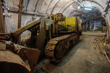 Fototapeta na wymiar Underground coal ore mine shaft tunnel gallery with harvester coal combine miner