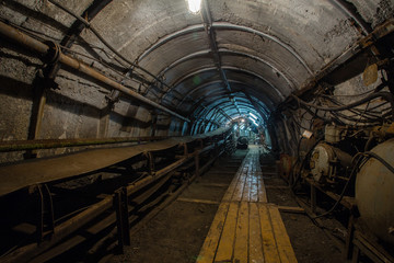 Underground coal ore mine shaft tunnel gallery with transporter conveyor