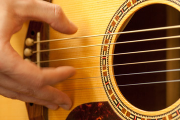 man hand playing acoustic guitar strings recreation concept