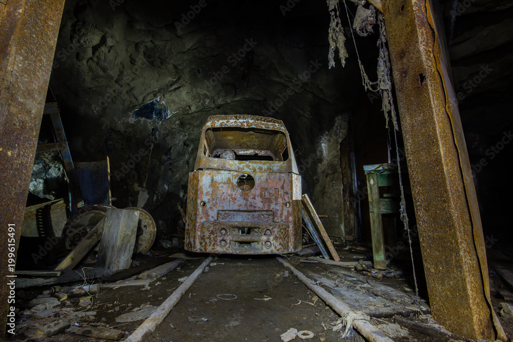 Wall mural underground abandoned gold ore mine shaft tunnel gallery with locomotive