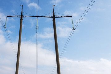 high-voltage tower on a blue sky background. With space for text