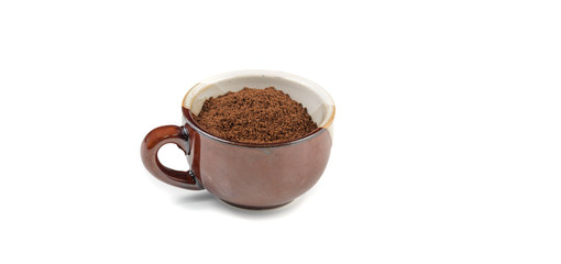 a ceramic espresso mug full of freshly ground coffee