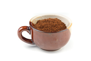a ceramic espresso mug full of freshly ground coffee