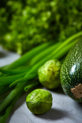 Fresh vegetables still life over white textured background, close-up, flat lay.
