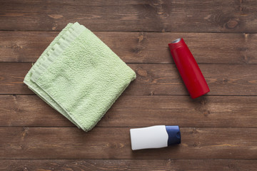 Composition with plastic bottles and towel of body care and beauty products top view flat lay