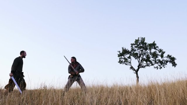 Cinemagraph - Two warriors Viking are fighting with swords